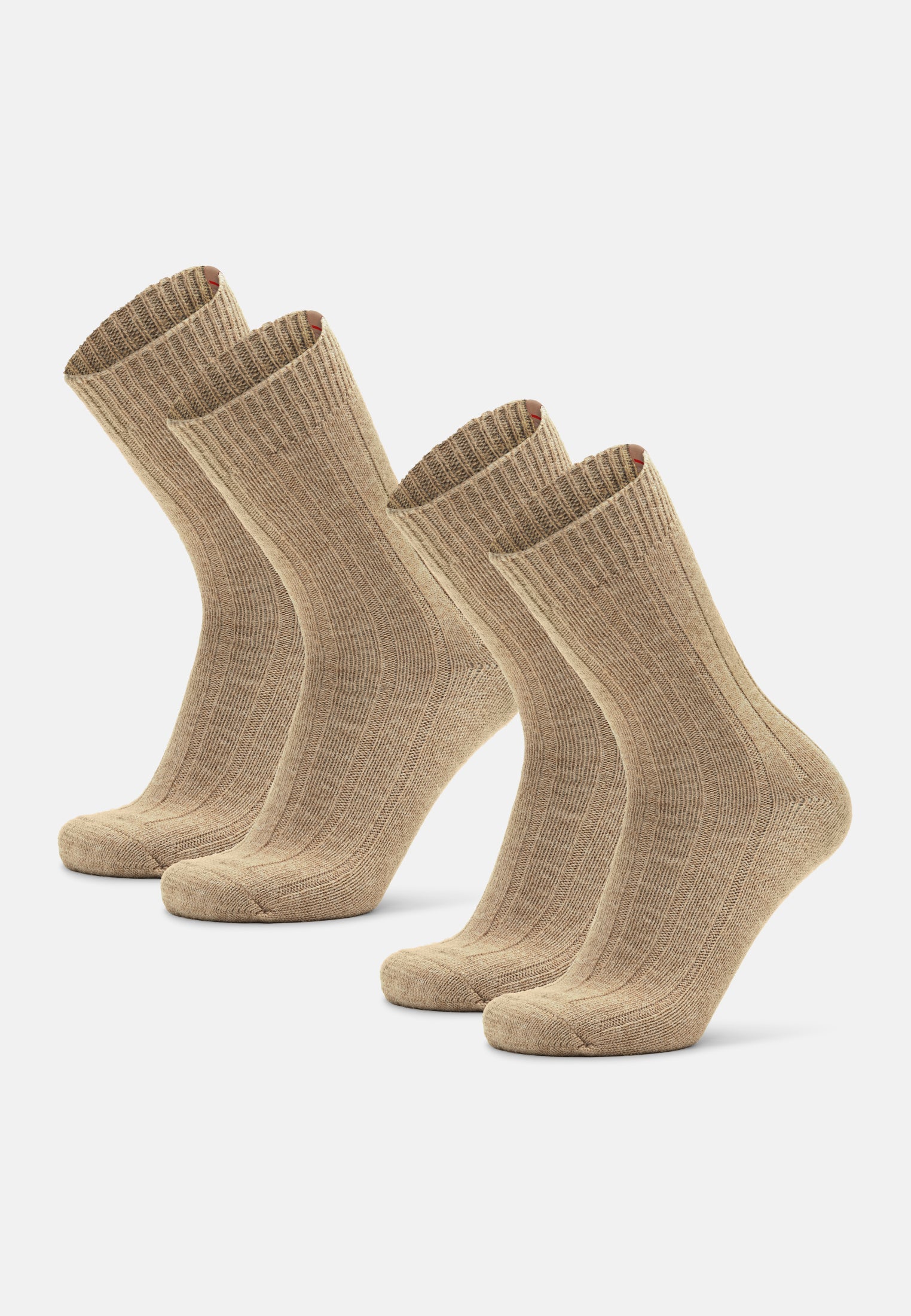 Three pairs of beige alpaca wool socks standing upright on a white background.