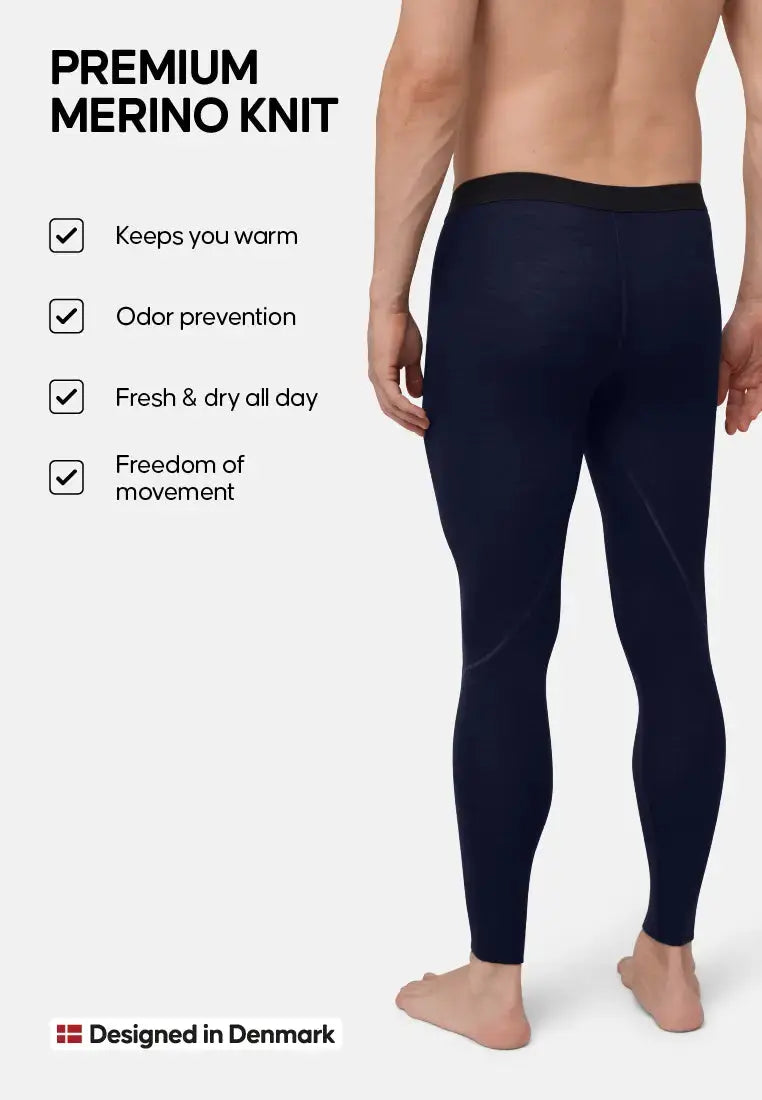 Man wearing navy merino wool pants, features listed: warmth, odor control, freshness, mobility.