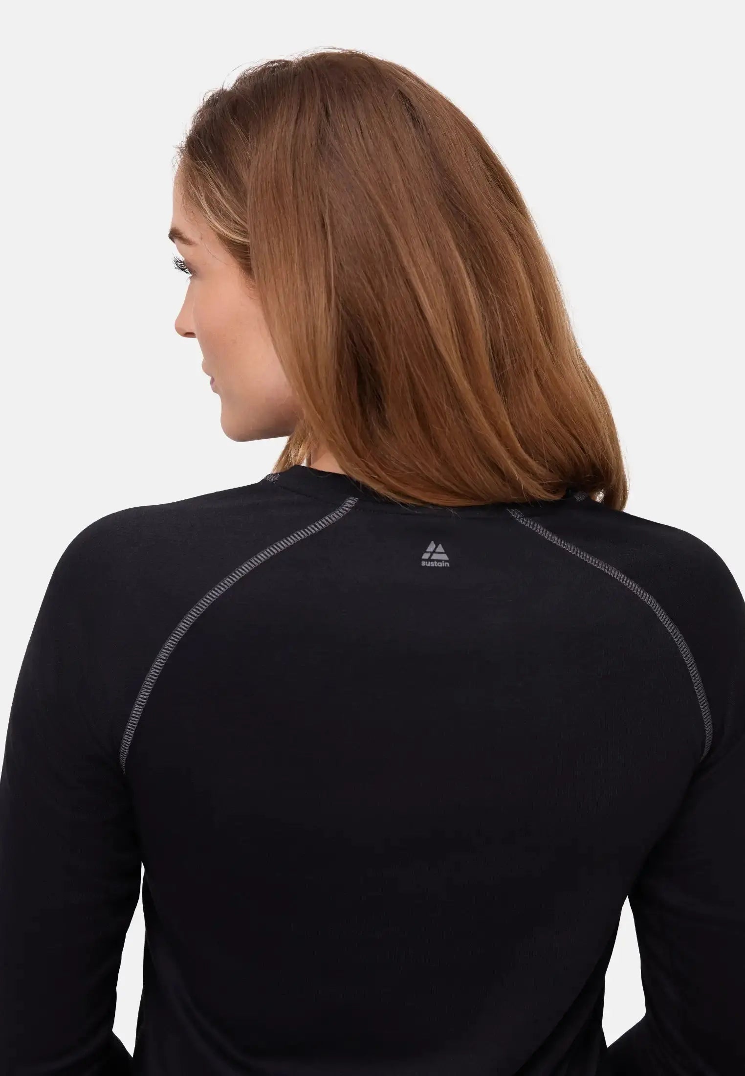Person wearing a black thermal top, viewed from the back, showing shoulder seams and smooth fabric.