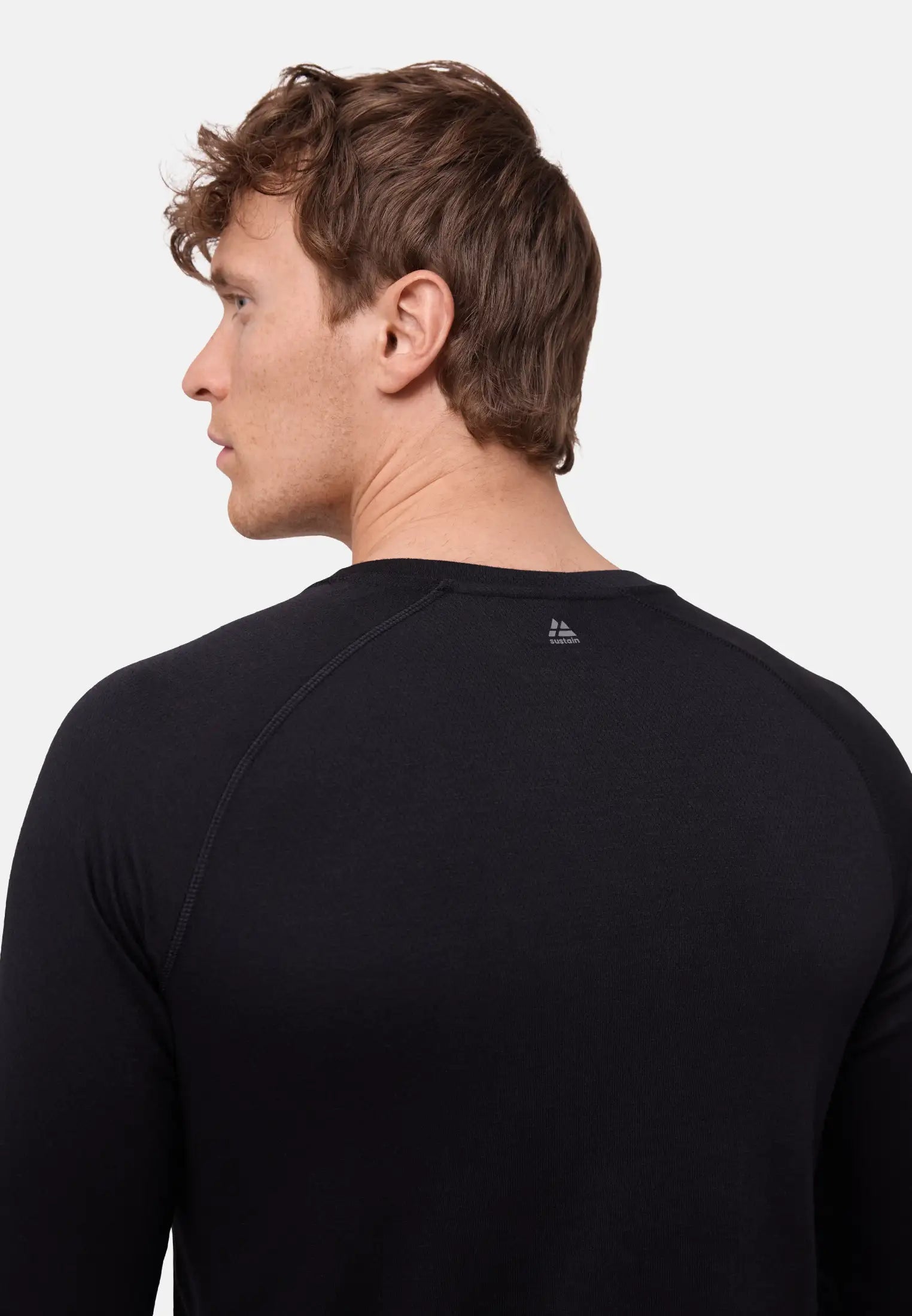 Back view of a person wearing a black thermal top, showcasing fabric texture and fit.