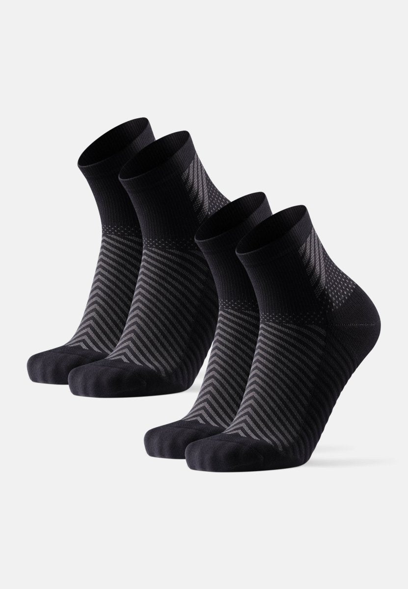 Four pairs of black anti-slip running socks with subtle stripes, displayed in a row.