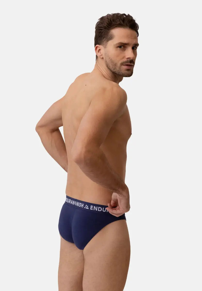 Man wearing dark blue bamboo briefs with "Endur" waistband, viewed from the back.