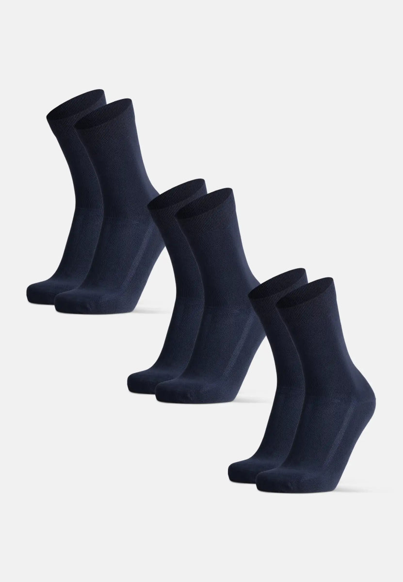 Four pairs of navy blue bamboo dress socks, neatly lined up against a plain background.