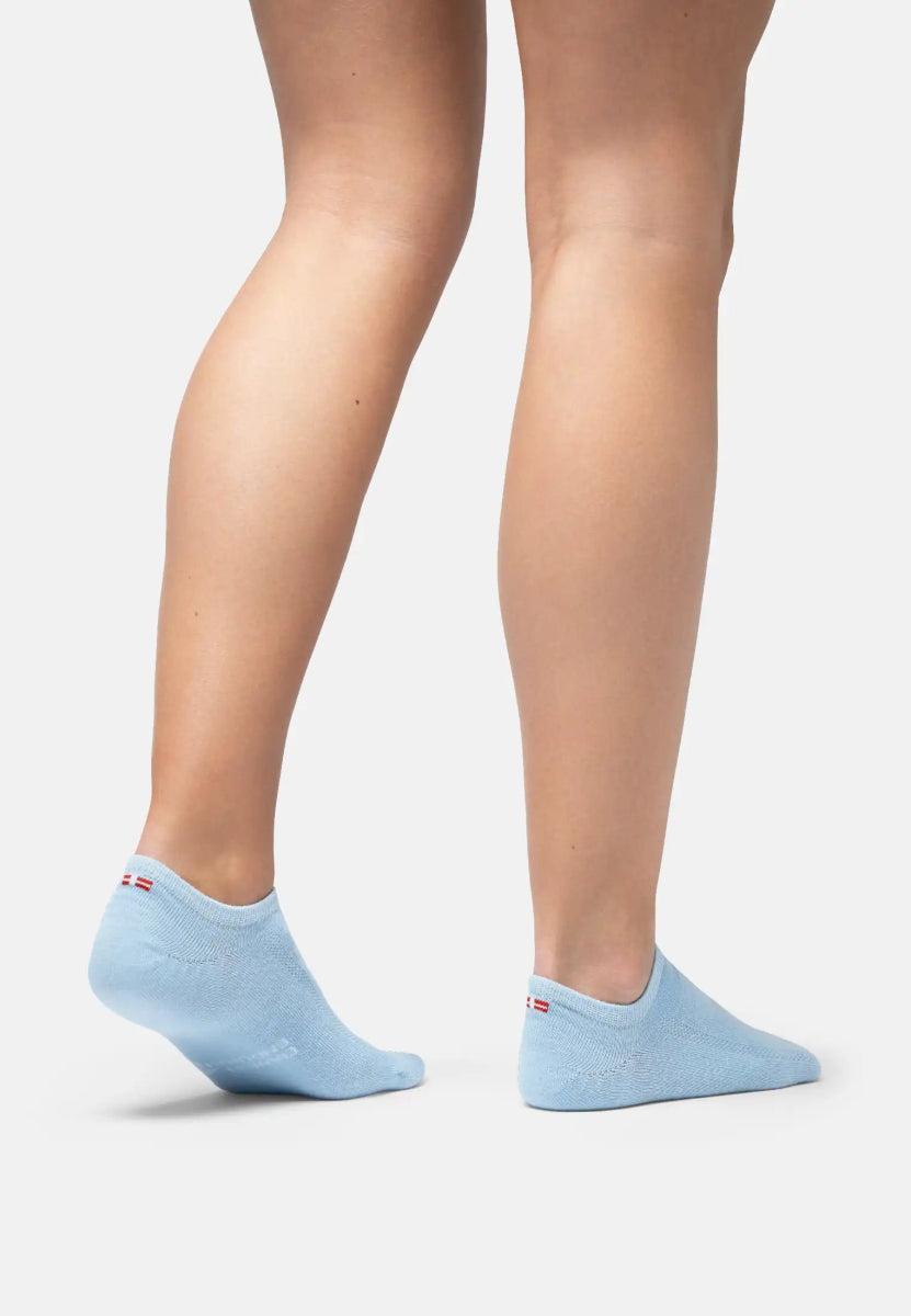 Light blue bamboo no-show socks on feet, showcasing low-cut design and subtle fit.