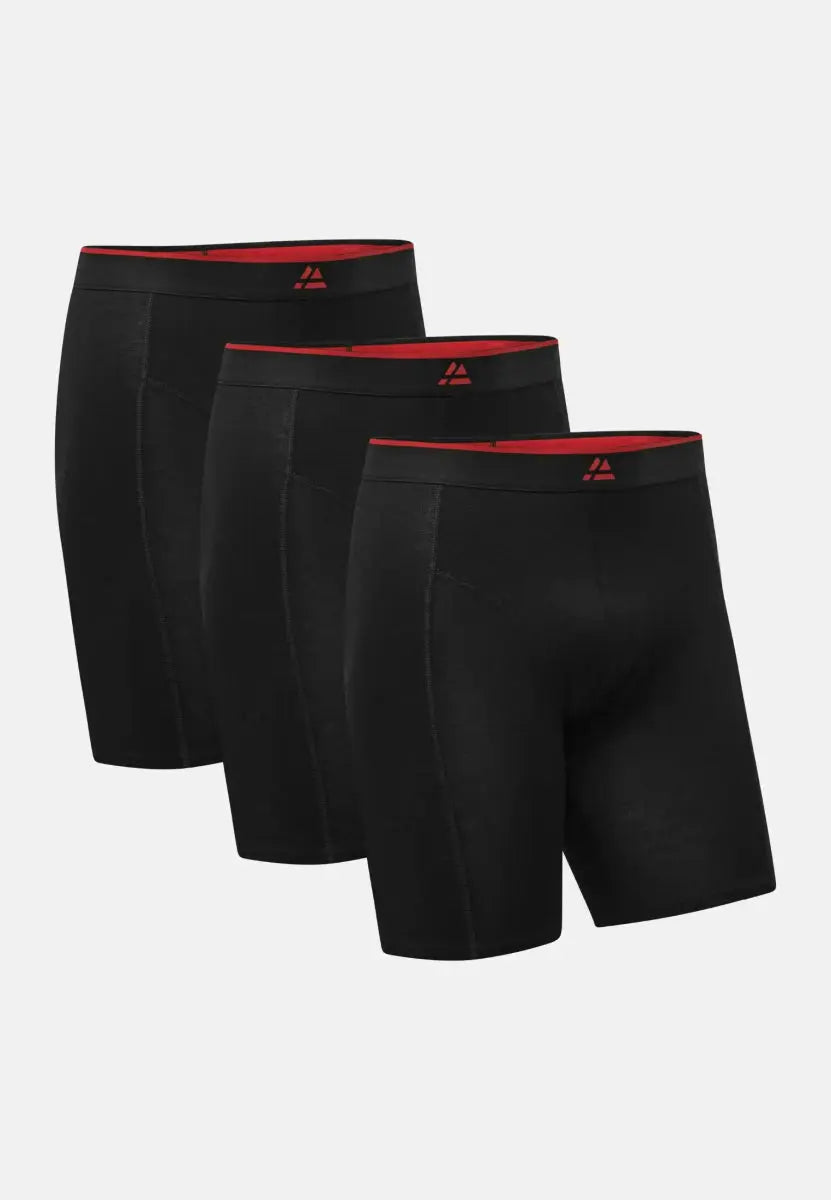 Three pairs of black bamboo trunks with red waistbands and logo, aligned in a row.