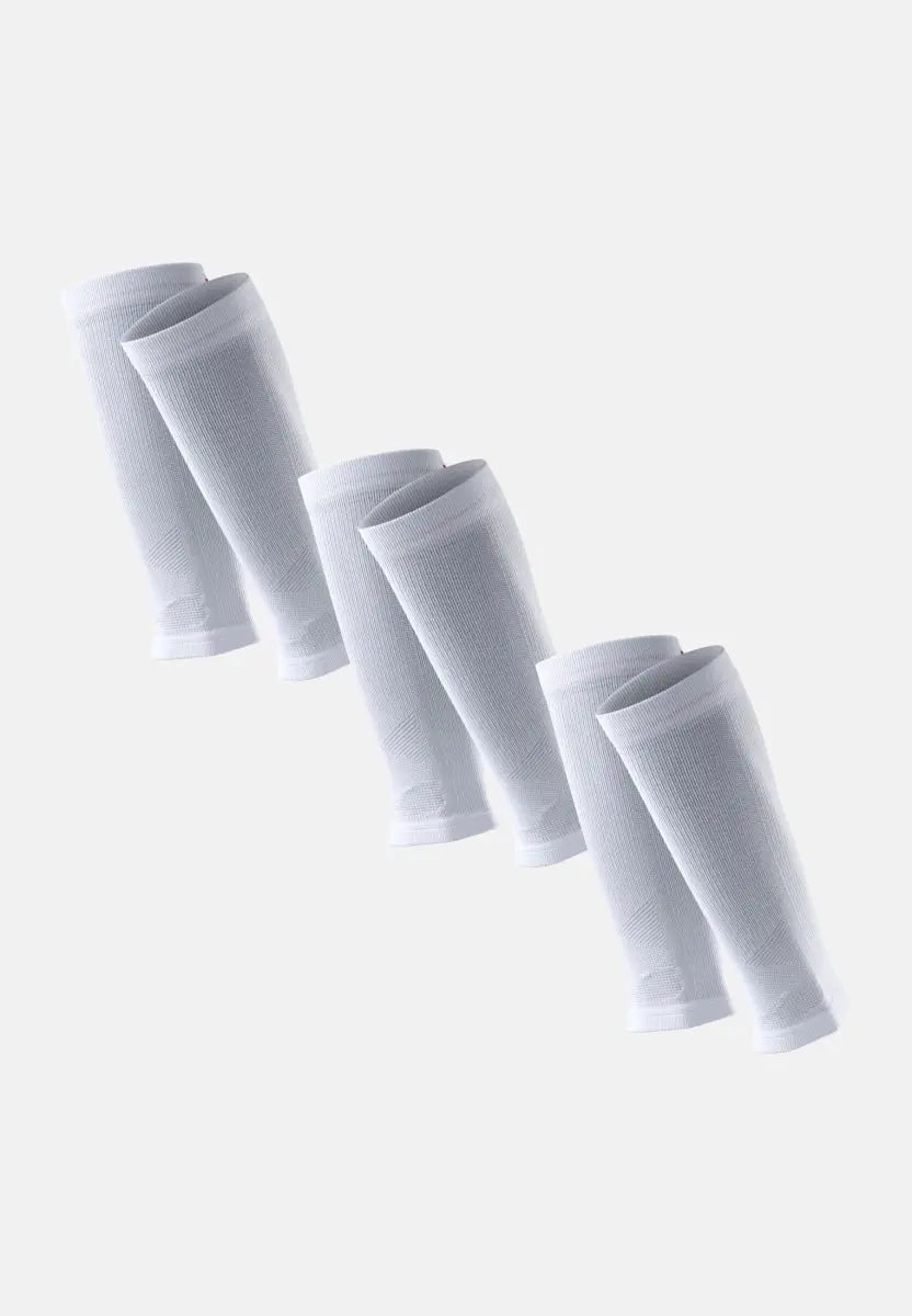Three pairs of white calf compression sleeves in a diagonal arrangement on a light background.