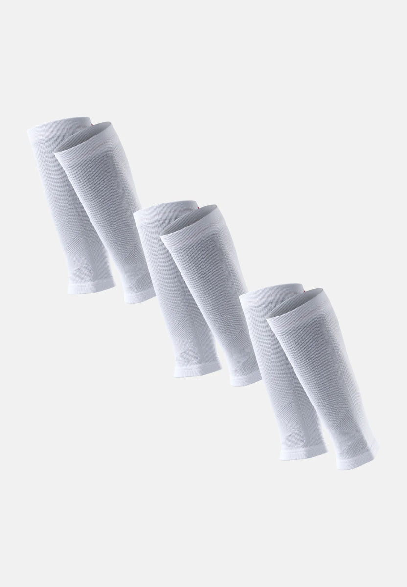 Three pairs of white calf compression sleeves in a diagonal arrangement on a light background.