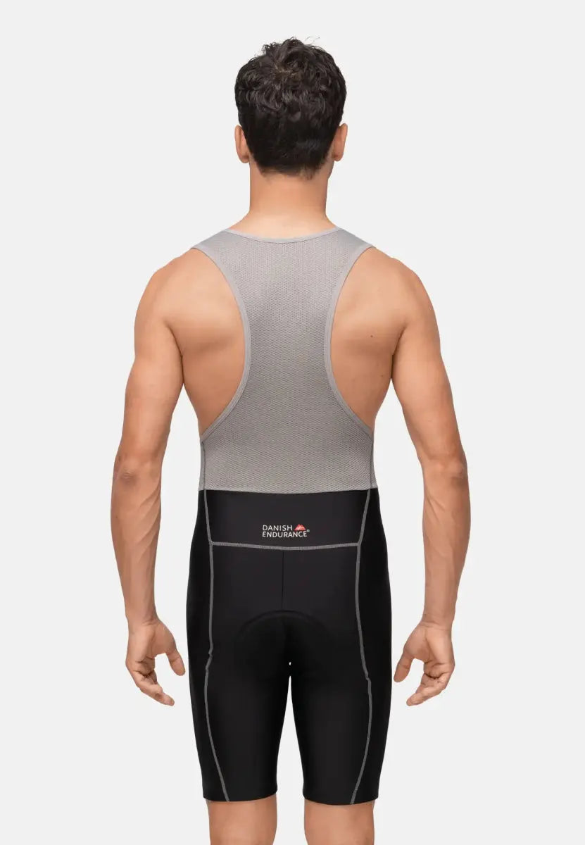 Man in gray and black cycling bib shorts, seen from the back.