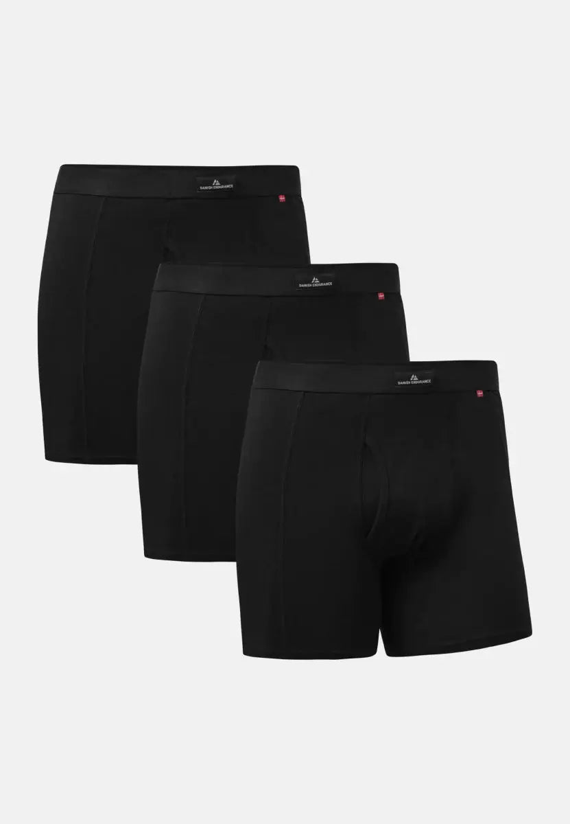 Three black trunks with fly, branded waistband, displayed in a staggered arrangement.
