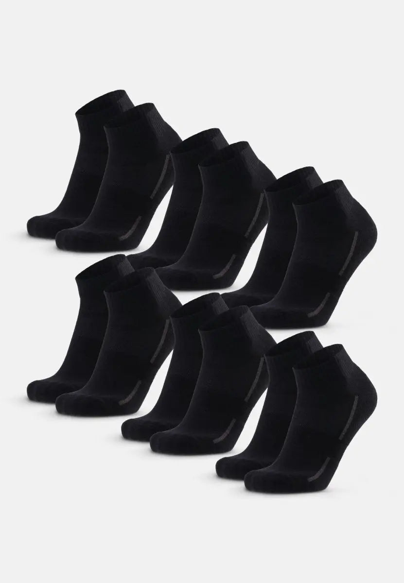 Multiple pairs of black cotton quarter socks are neatly displayed in two rows on a white background.