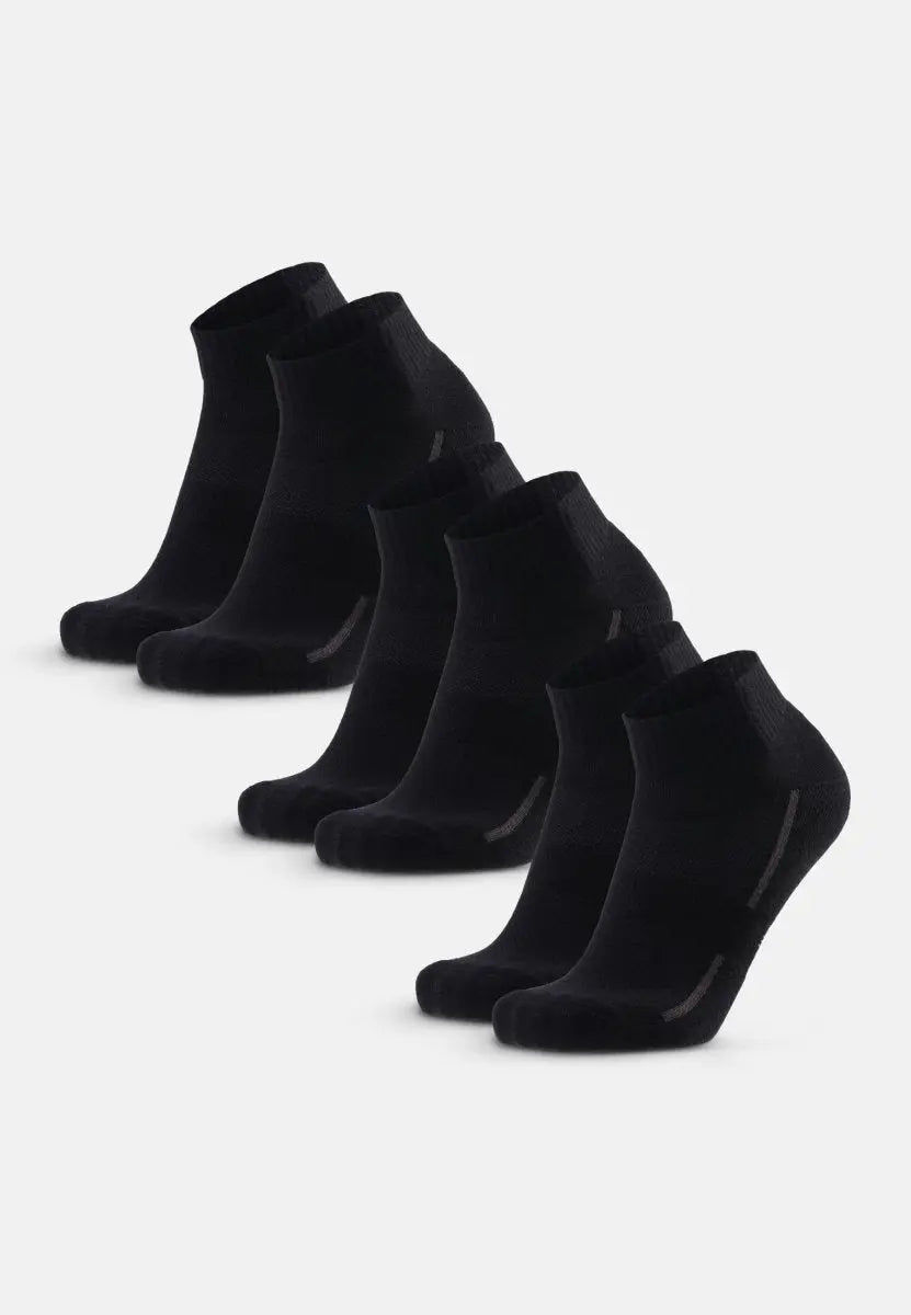 Six pairs of black cotton quarter socks arranged in two rows on a white background.