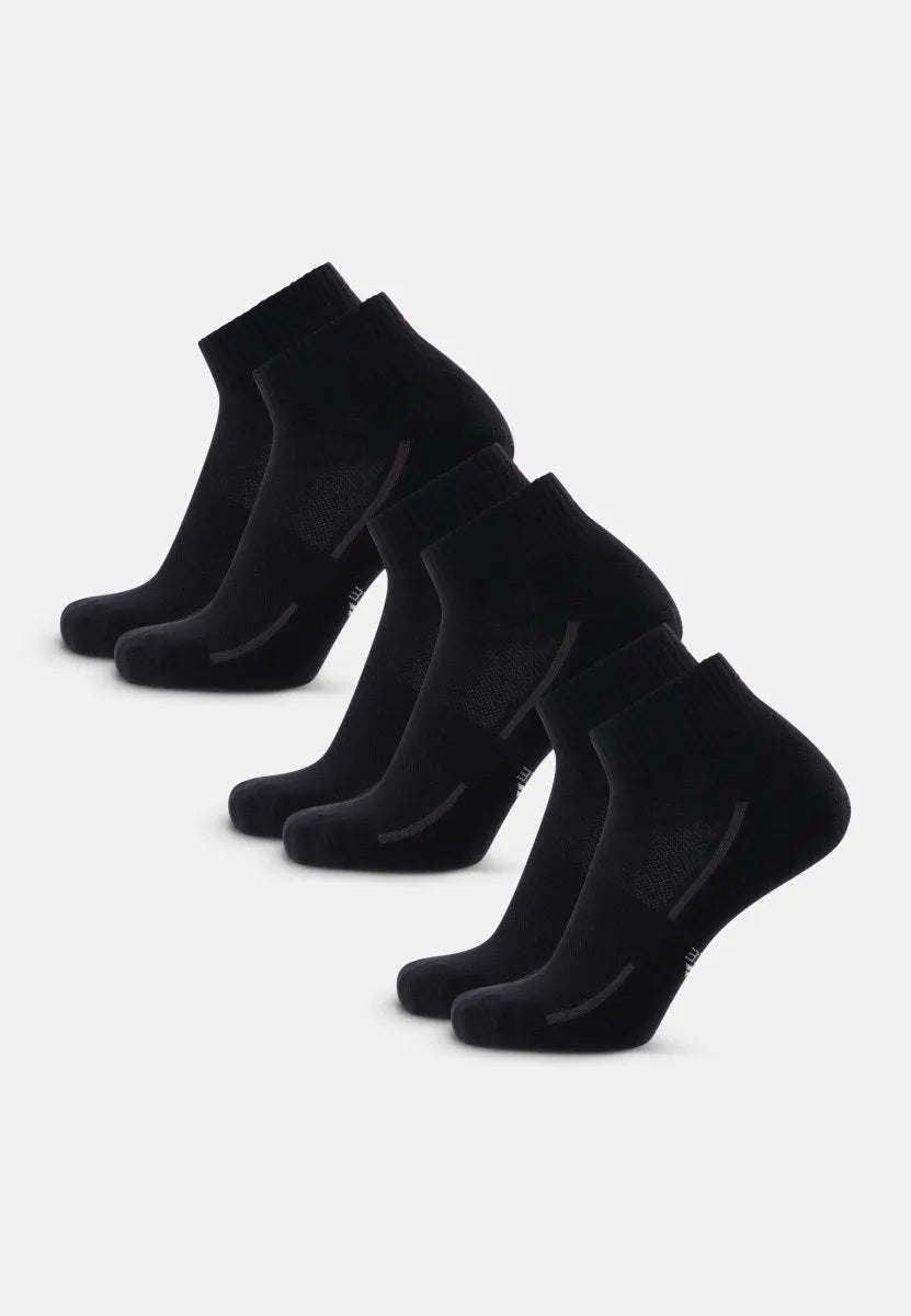 Five pairs of black cotton quarter socks with ribbed cuffs, aligned in a neat row.