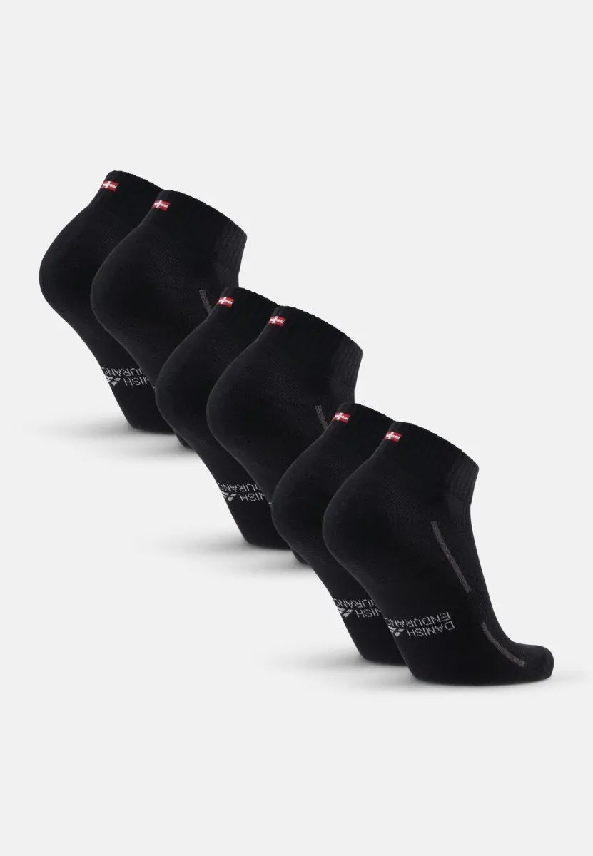 Four pairs of black cotton quarter socks with red and white tags, arranged in a row.