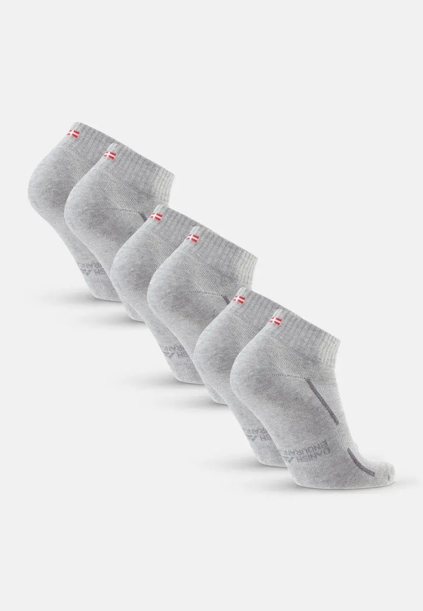 Five grey cotton quarter socks with red and white flag detail, aligned in a row.