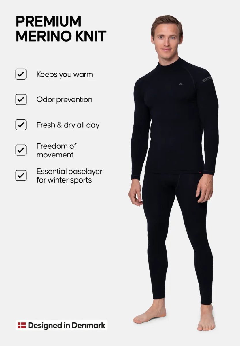 Man in black merino wool set, features: warm, odor-free, dry, flexible, winter sports. Designed in Denmark.