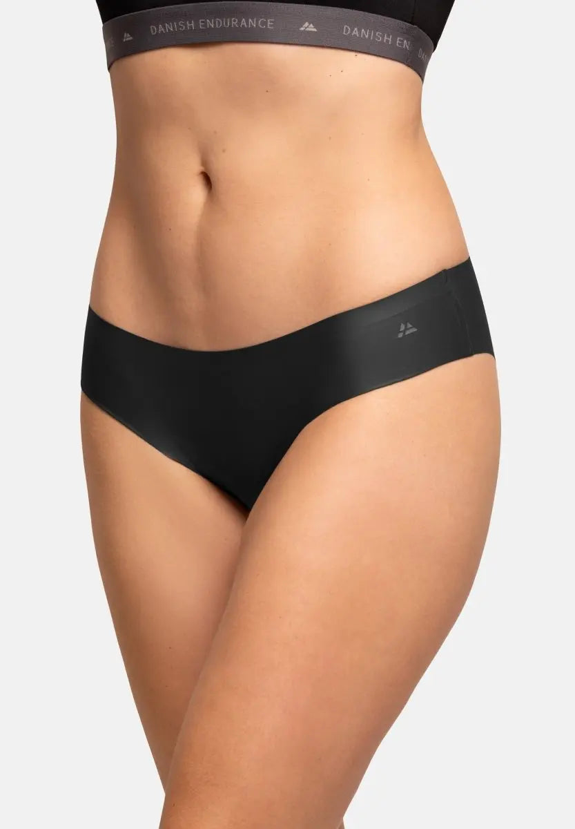 Close-up of a person wearing seamless black bikini panties and a matching waistband.