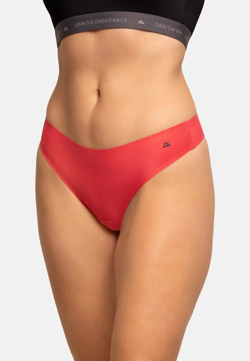 Person wearing red thong panties, showing waist and hips.