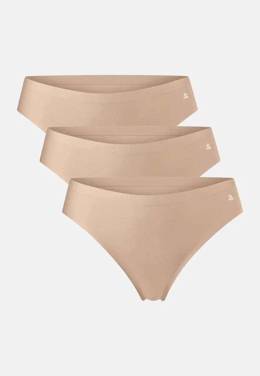 Three nude seamless thong panties with a small logo on the waistband, stacked slightly offset.