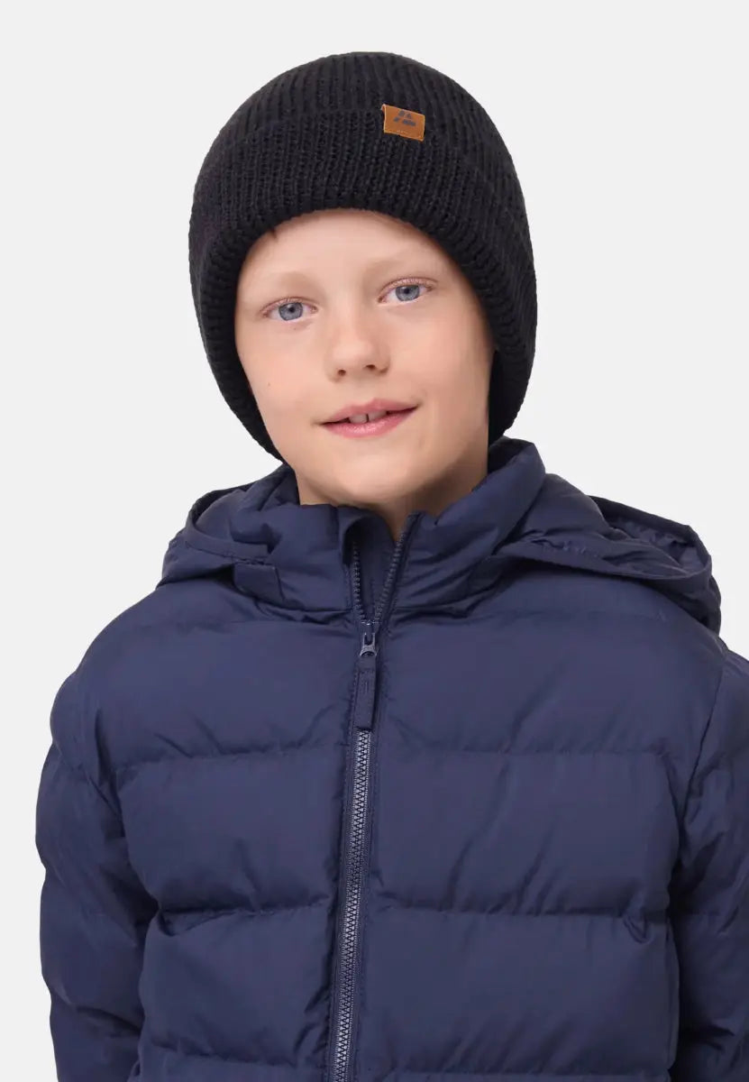 Child wearing a black beanie with a brown logo and a navy puffer jacket.