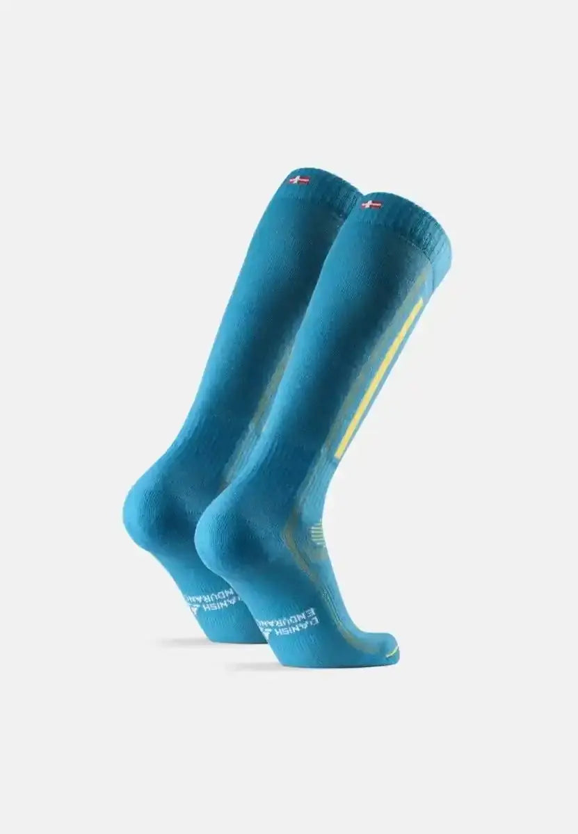 Bright blue merino wool ski socks with yellow stripes and flag detail at the top.