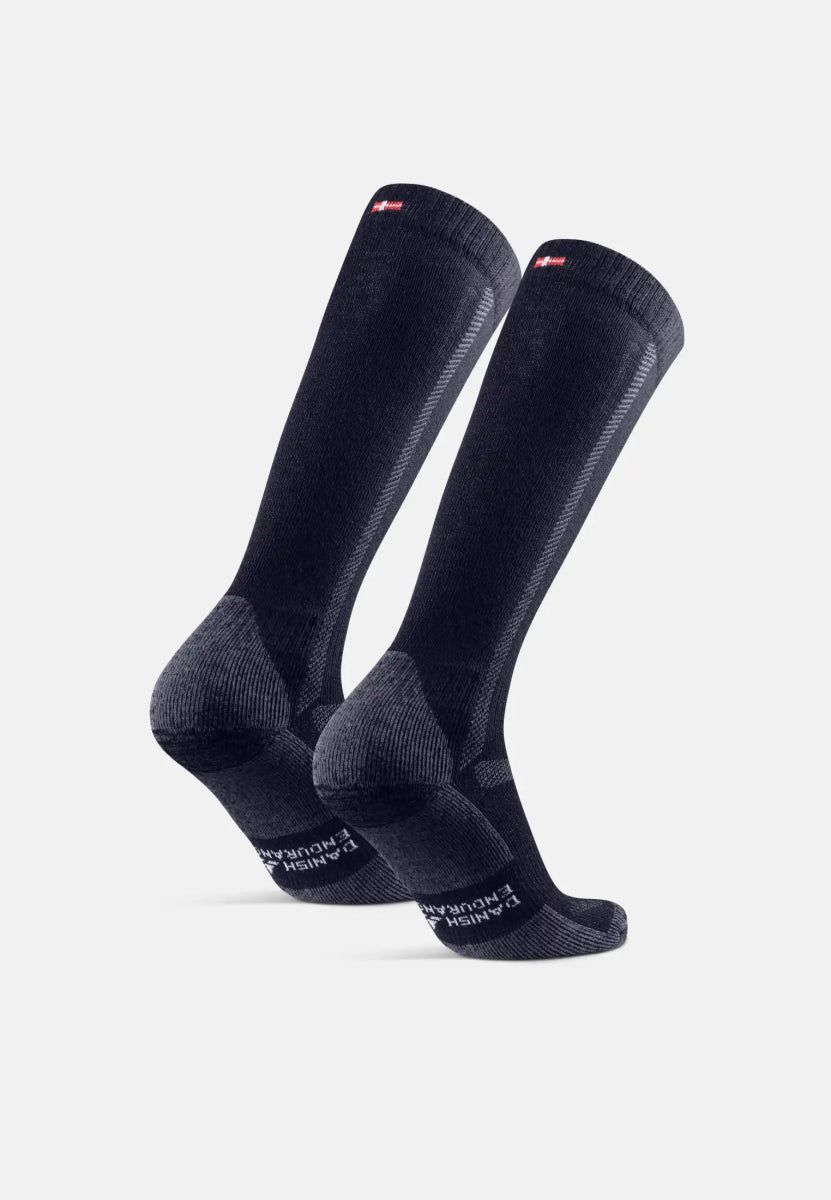 Two dark knee-high merino hiking socks with textured design and logo near the cuff.