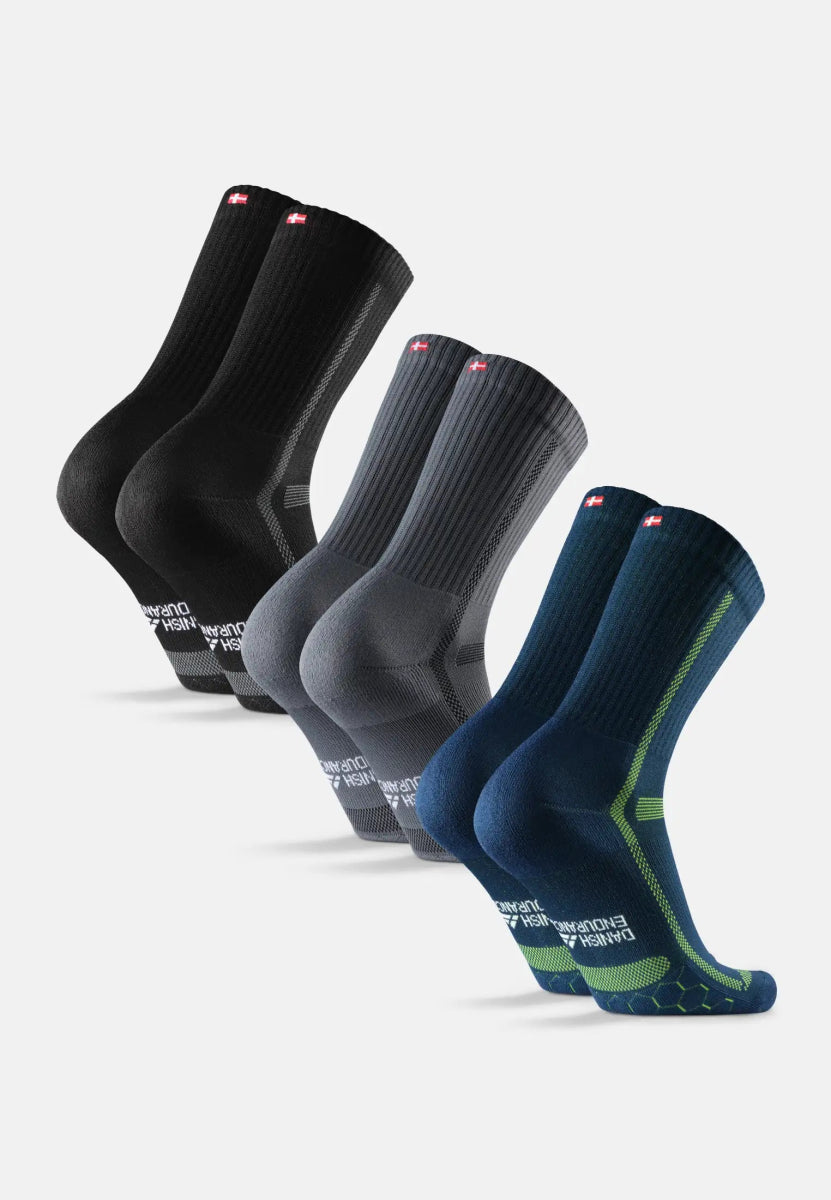 Three pairs of crew running socks in black, gray, and blue with green accents and flag details.