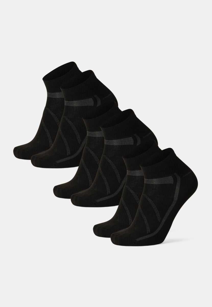 Six pairs of black low-cut cycling socks, arranged in two rows, on a white background.