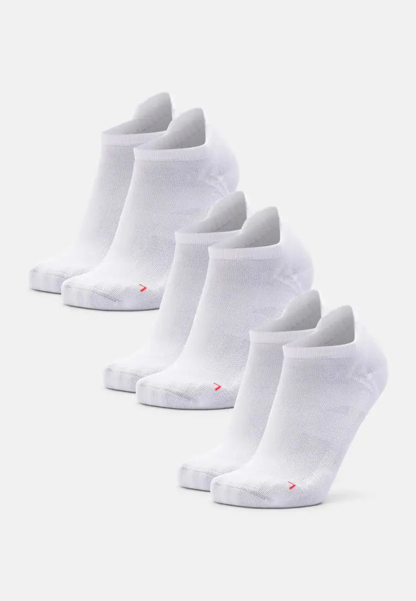 Five pairs of white low-cut running socks on a light background.