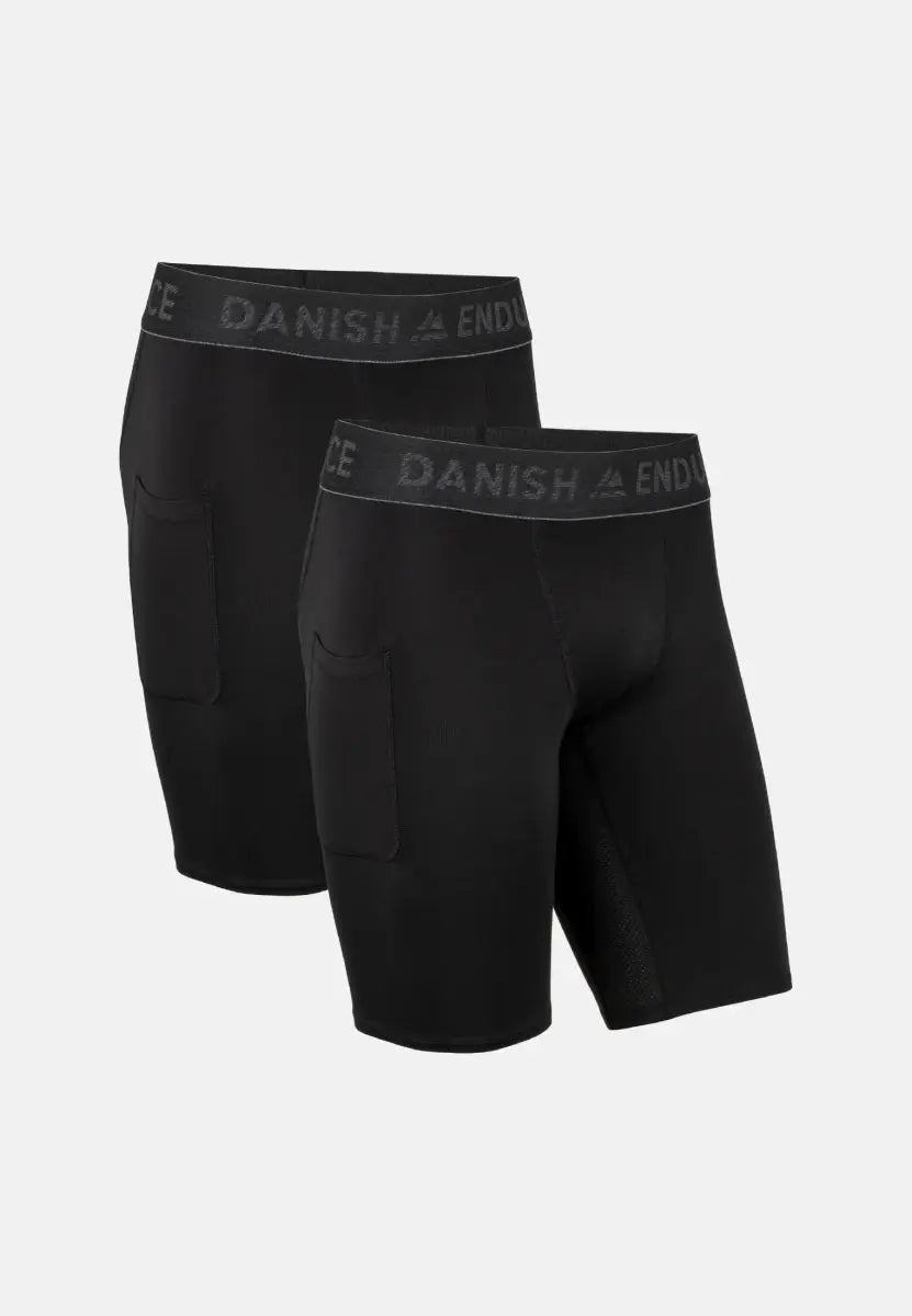Two pairs of black men's compression shorts with side pockets and "DANISH ENDURANCE" waistbands.