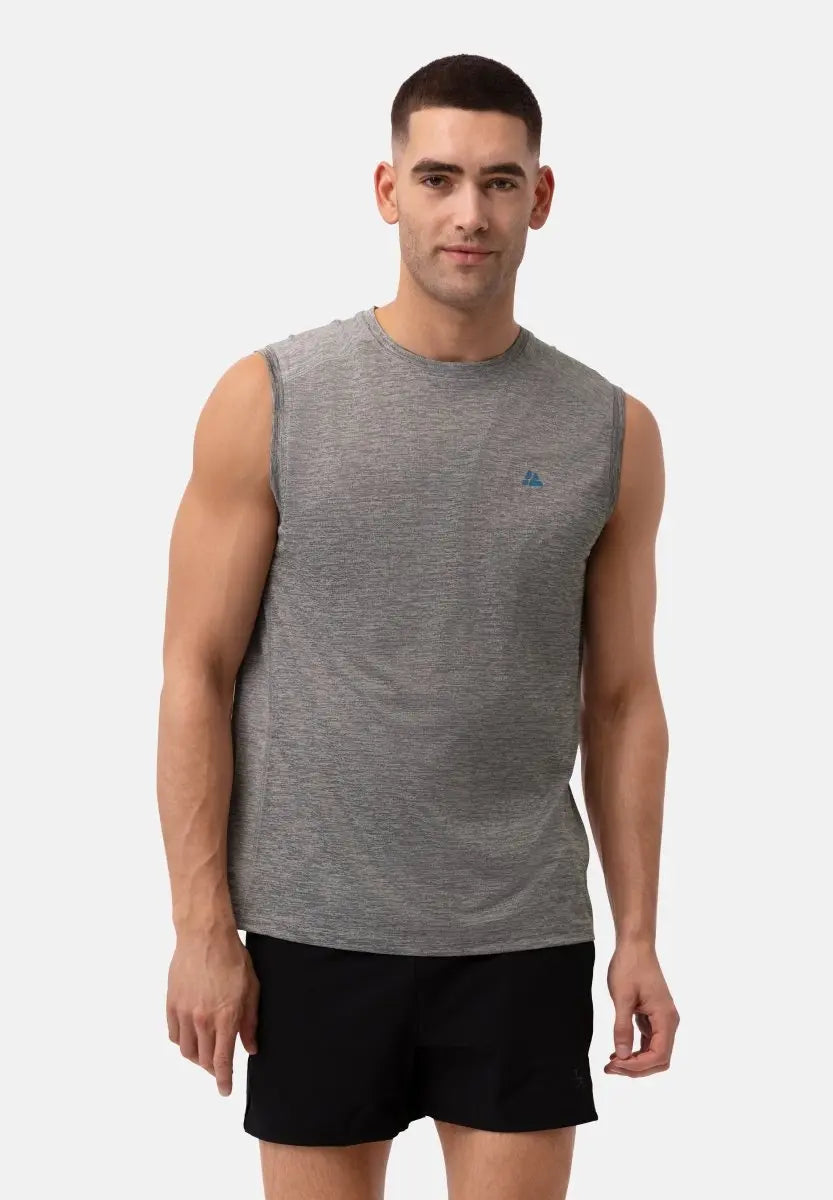 Man in gray sleeveless tank top and black shorts, standing against a white background.