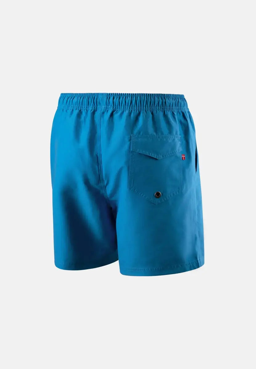 Blue swim trunks with elastic waist and back pocket featuring a button and small red logo.