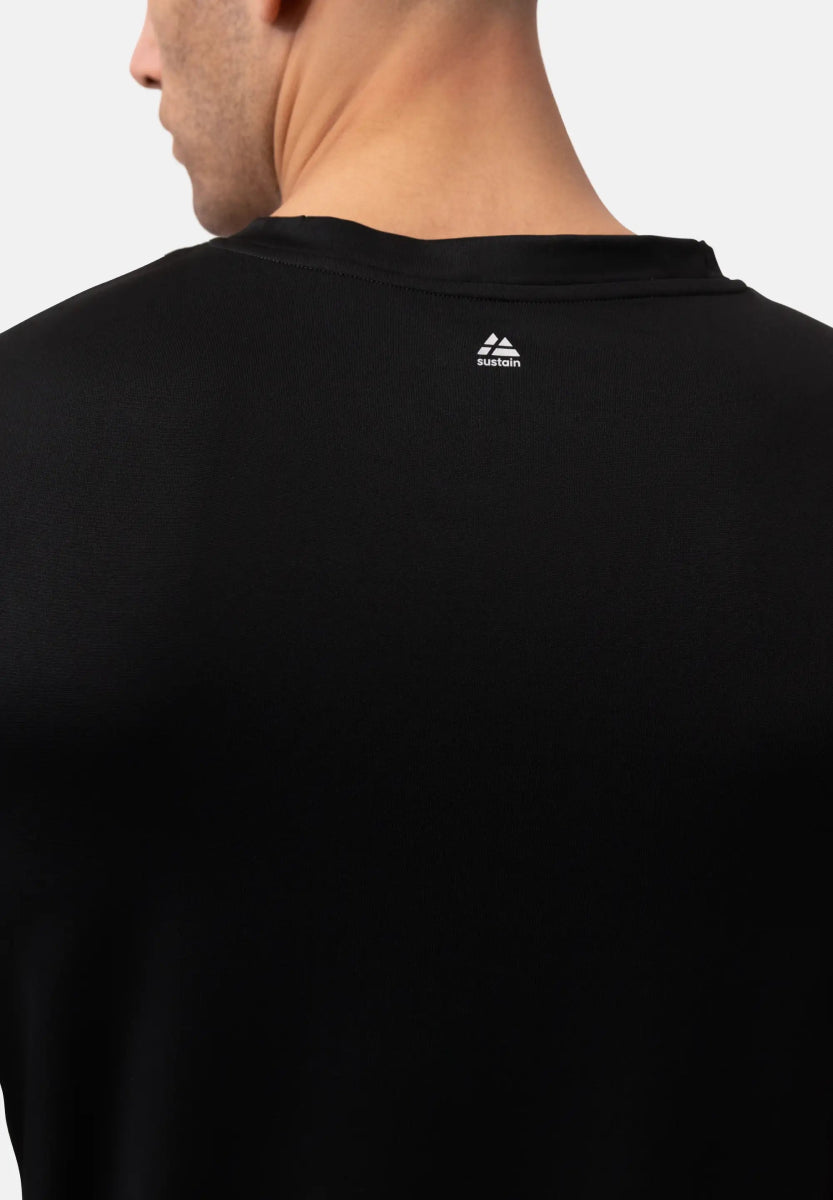 Back view of a black T-shirt with a white "sustain" logo near the neck.
