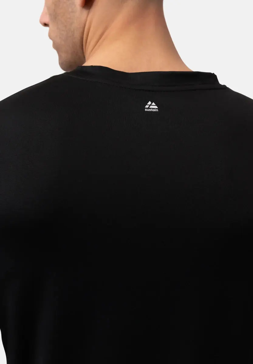Back view of a black T-shirt with a white "sustain" logo near the neck.