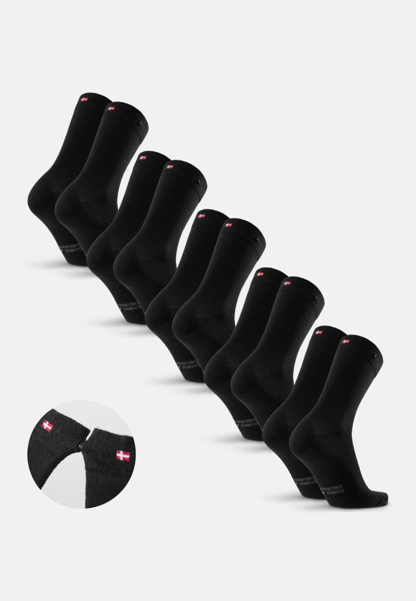 Black merino dress socks with red emblem and button detail, displayed in a set.