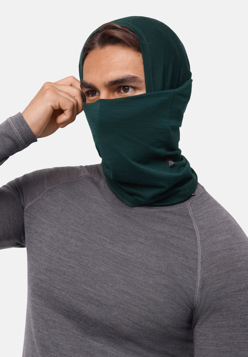 Person wearing a dark green neck gaiter over head and face, paired with a grey shirt.