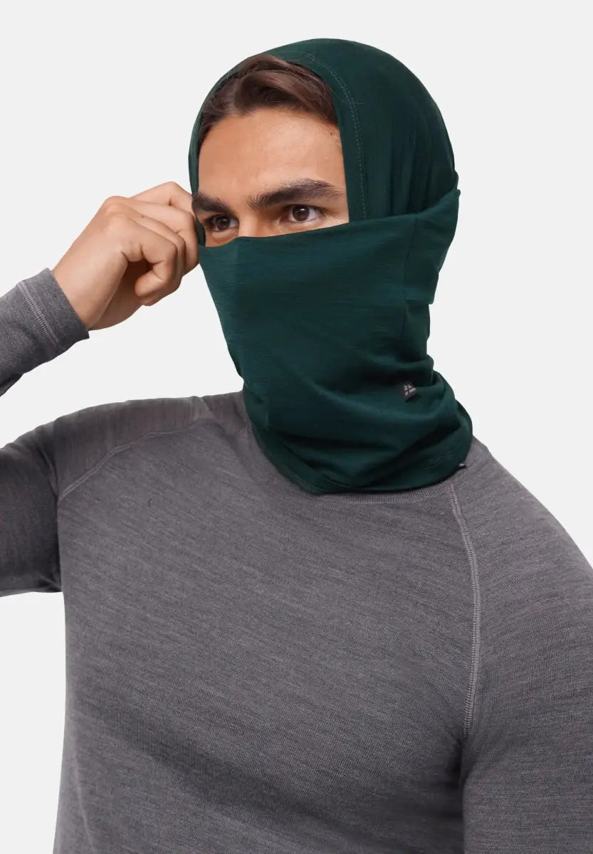Person wearing a dark green neck gaiter over head and face, paired with a grey shirt.