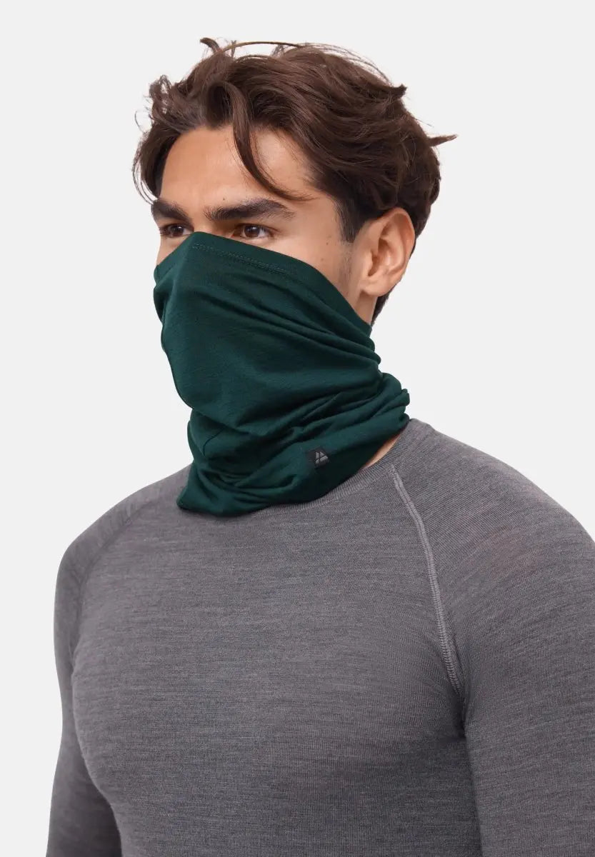 Person wearing a dark green neck gaiter covering nose to neck, paired with a gray shirt.