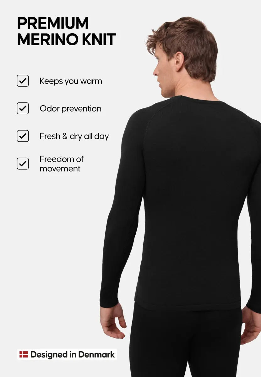Man in black Merino shirt; features: warmth, odor prevention, freshness, movement. Designed in Denmark.