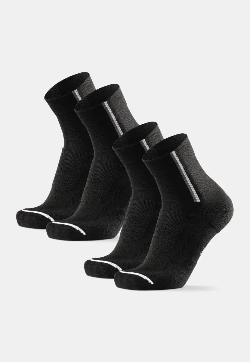 Four black merino wool cycling socks with white stripes, displayed on a plain background.