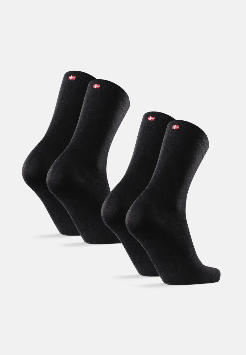 Two pairs of black Merino wool hiking liner socks with red and white logos on the cuffs.