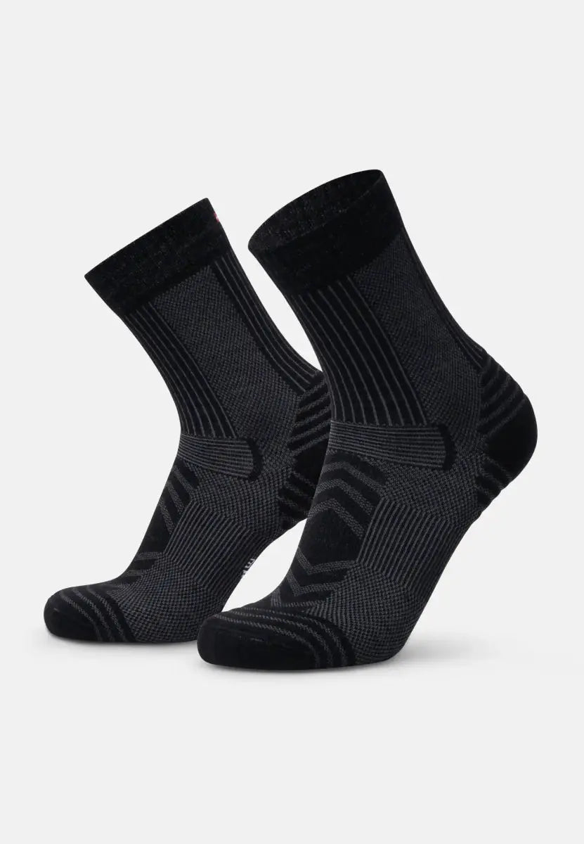 Black merino wool hiking socks with ribbed pattern and reinforced heels and toes.