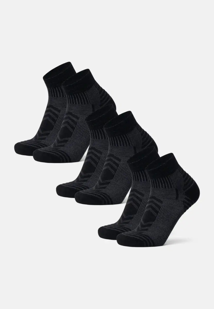 Five pairs of black merino wool low-cut hiking socks, arranged in a neat row.