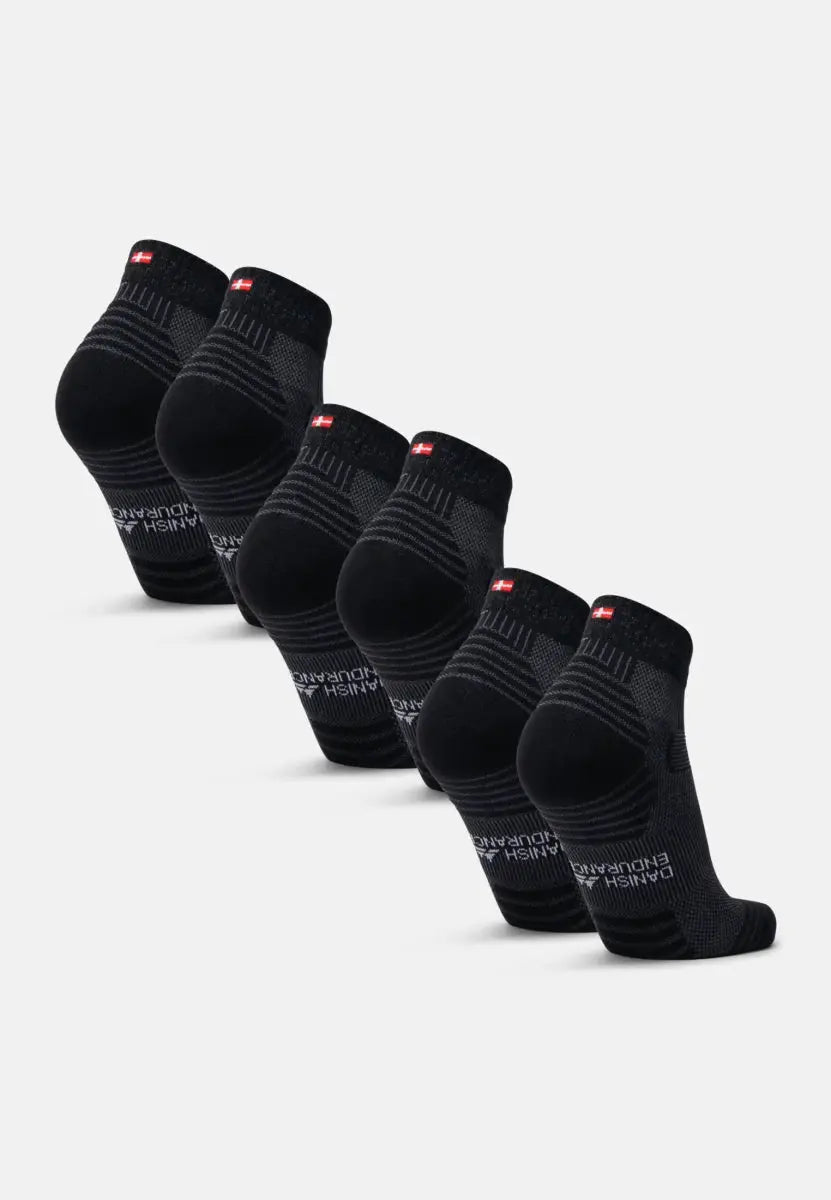 Five pairs of black low-cut socks with red logo, arranged in a neat row on a white background.