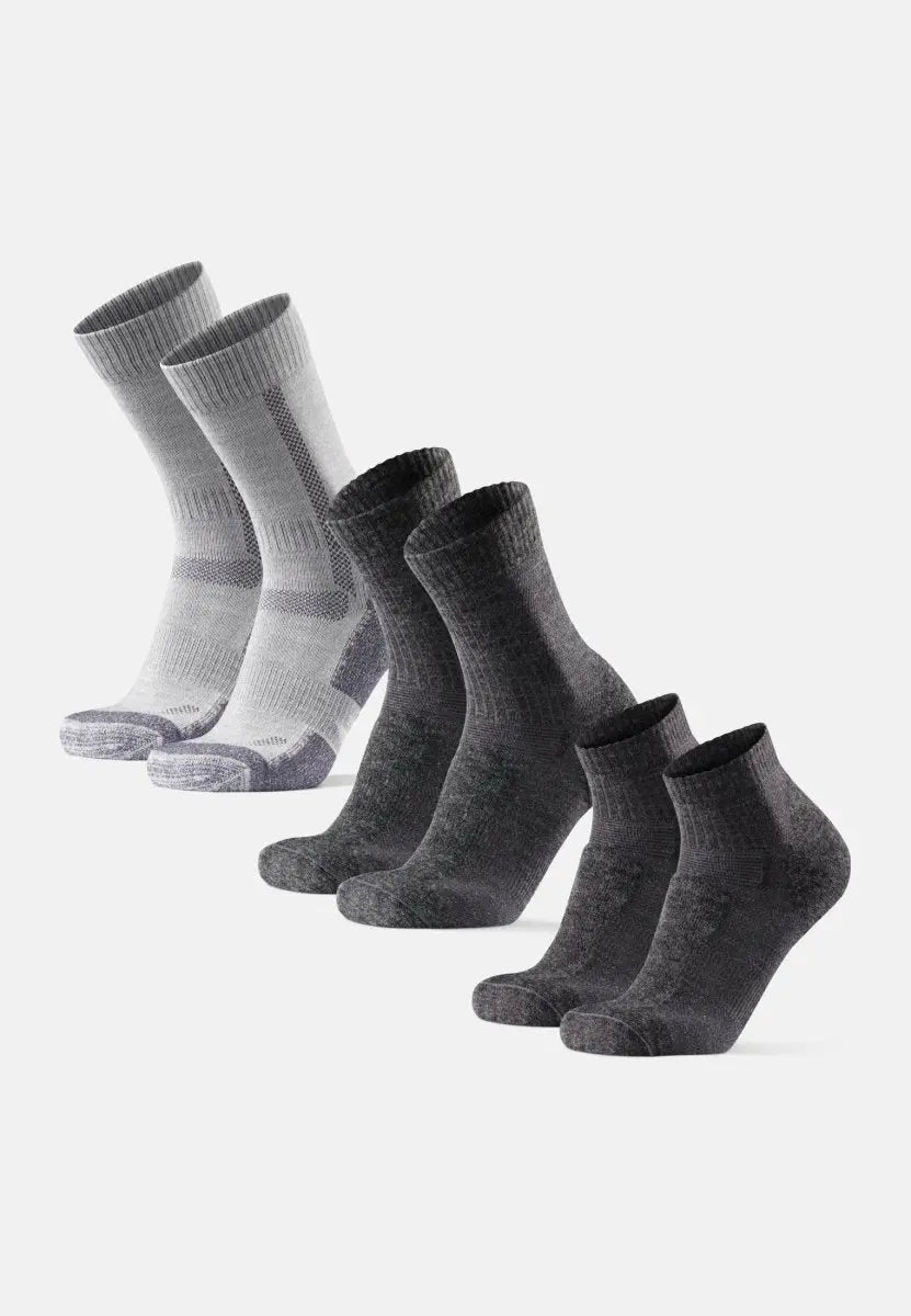 Three pairs of gray merino wool hiking socks, arranged light to dark, with ribbed cuffs.