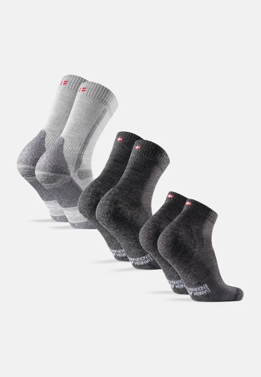 Three pairs of grey merino wool hiking socks, each with a small flag detail, displayed in a row.