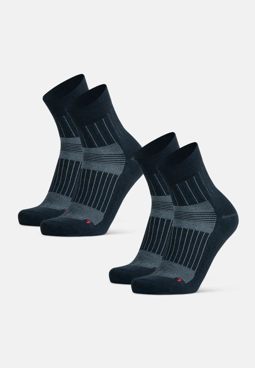 Two pairs of black and gray merino wool socks with stripes on a plain white background.