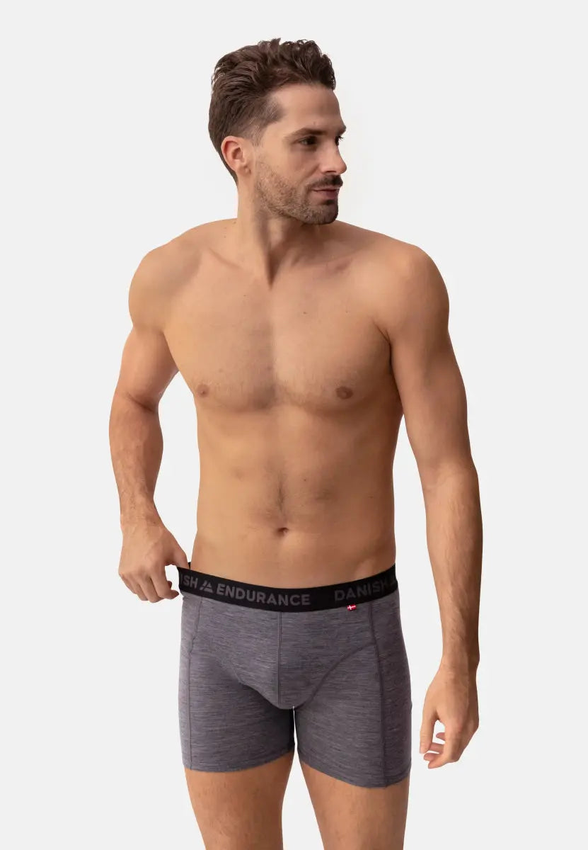 Man wearing gray Merino wool trunks with a black waistband that reads "Danish Endurance."
