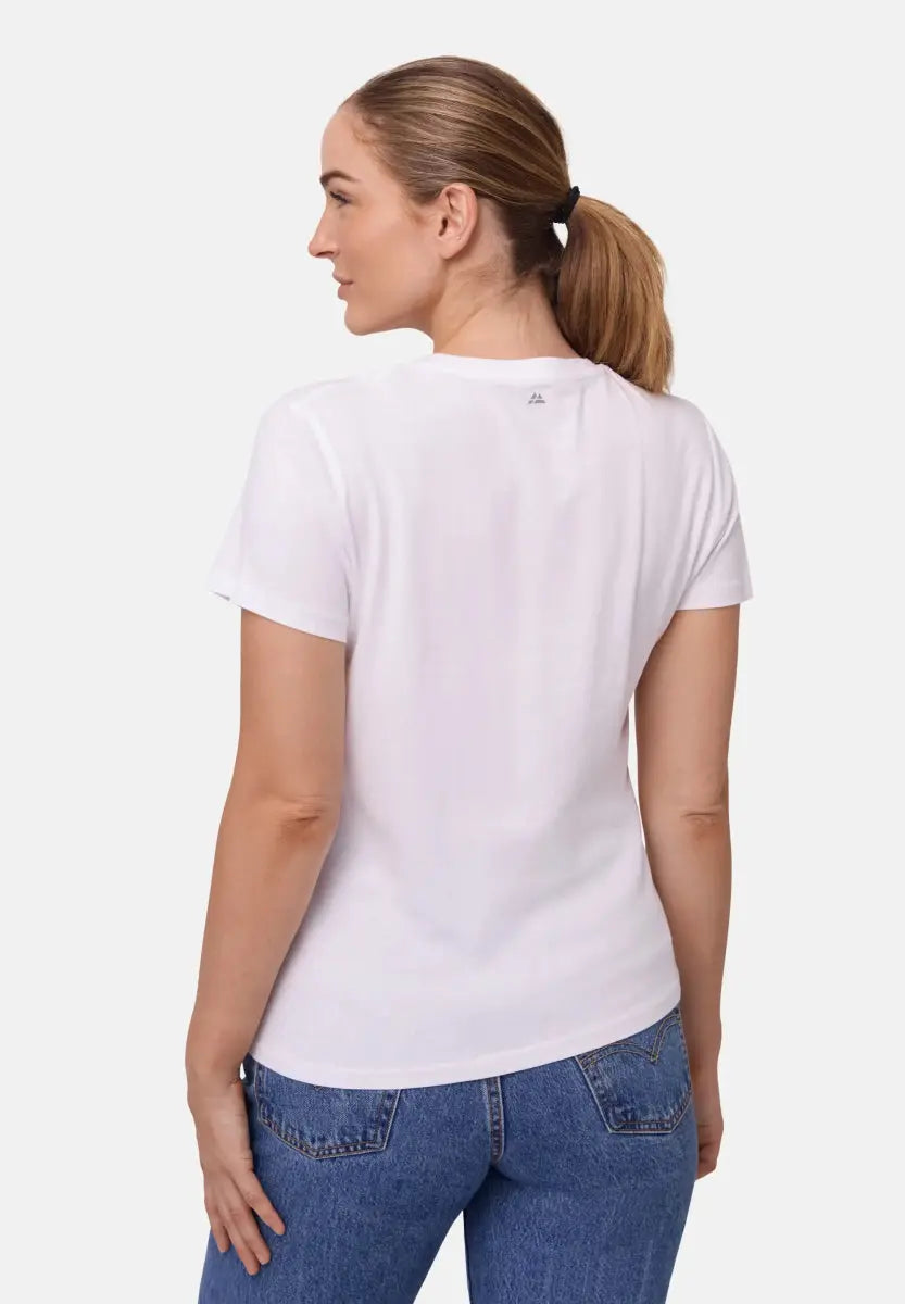 Woman in a white crew neck T-shirt and blue jeans, viewed from the back.