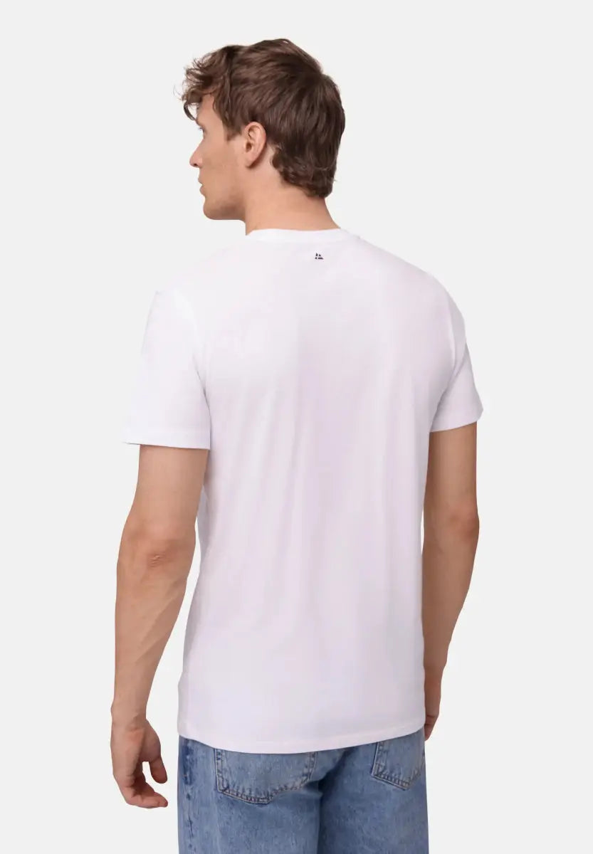 Man in a white V-neck T-shirt and blue jeans, viewed from the back, on a plain background.