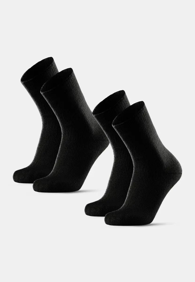 Four black non-slip heat socks stand upright on a white background.
